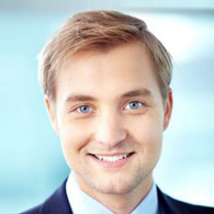 A man with blonde hair and blue eyes.